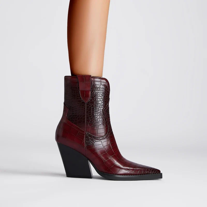 Brown crocodile-patterned ankle boot on a light gray background