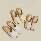 Pair of beige and white open-toe shoes on a beige background