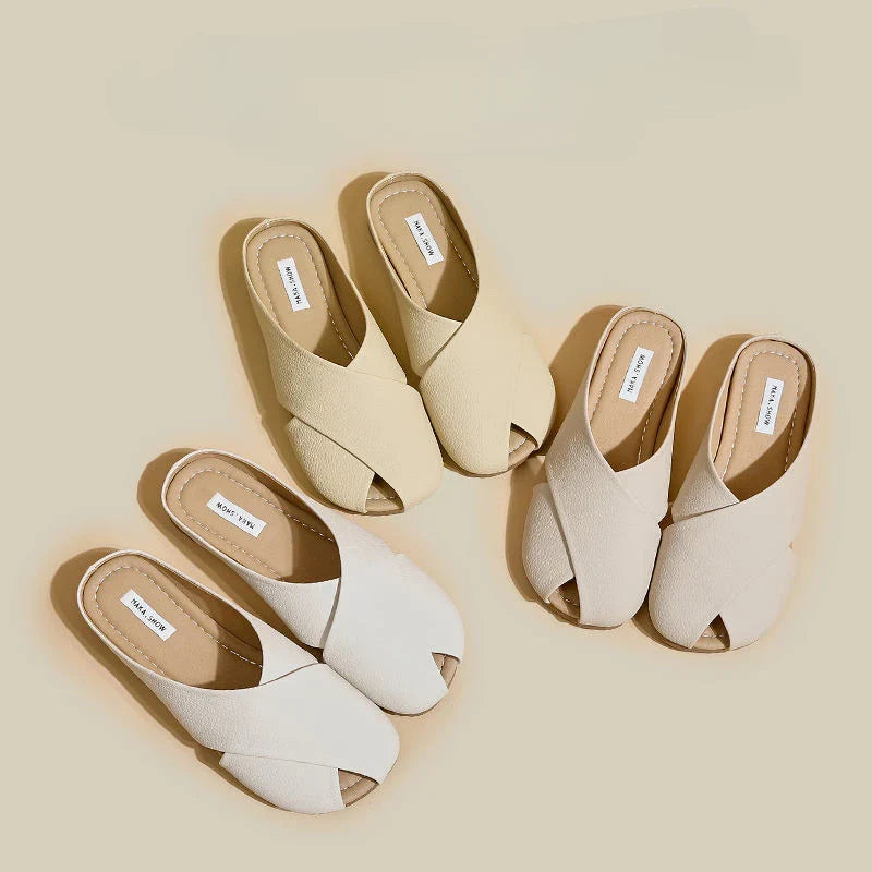 Pair of beige and white open-toe shoes on a beige background