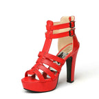 Red high-heeled sandal with multiple straps on a white background