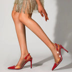 Red high-heeled shoes worn with a gold fringe skirt on a neutral background