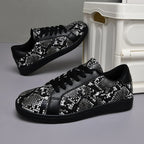 Black and silver sequin sneakers on a gray surface with a white box in the background.