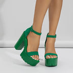 Green platform sandals worn by a person on a white background